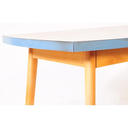 560 - British Modern Design - A mid 20th century formica topped kitchen dining table. The table raised on ... 