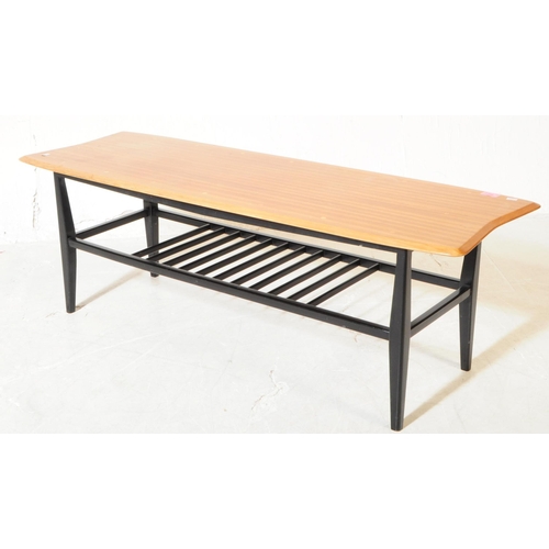 562 - A mid 20th century beech coffee table, in the manner of Ercol, alongside another. The Ercol manner c... 