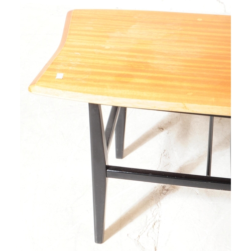 562 - A mid 20th century beech coffee table, in the manner of Ercol, alongside another. The Ercol manner c... 