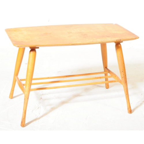 562 - A mid 20th century beech coffee table, in the manner of Ercol, alongside another. The Ercol manner c... 