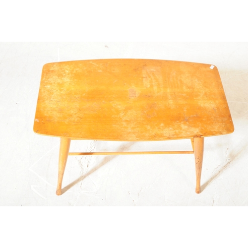 562 - A mid 20th century beech coffee table, in the manner of Ercol, alongside another. The Ercol manner c... 