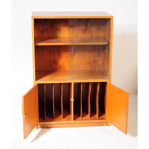 564 - British Modern Design - A mid 20th century beech wood glazed bookcase display cabinet. The cabinet r... 