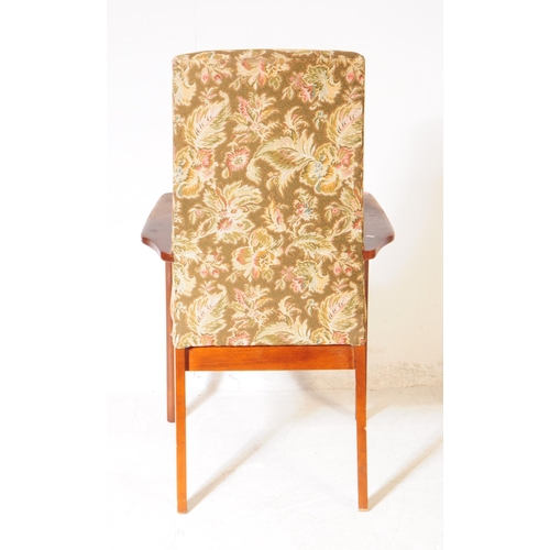 565 - Parker Knoll - A mid 20th century Parker Knoll PK 928/9 lounge armchair. The chair having shaped woo... 