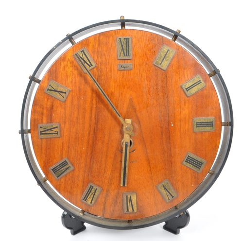 567 - Majak - A mid Century wooden Majak wall clock having brass plaque squares around the edge with black... 