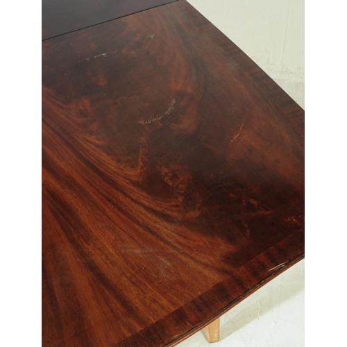 568 - A mid 20th century walnut veneer extending dining table. The table having armorial shaped top, raise... 