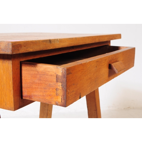 574 - A mid 20th century circa 1940s oak wood school / draughtsman desk. The desk having a top of rectangu... 