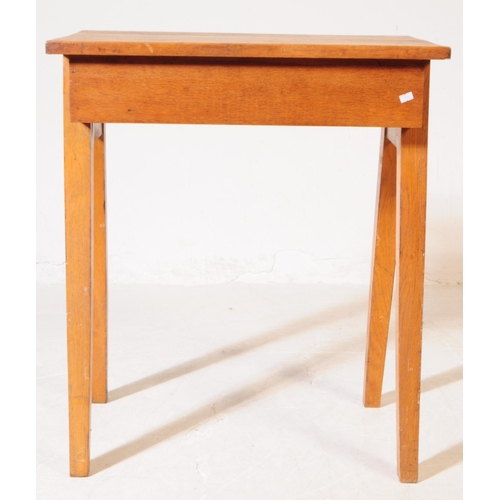 574 - A mid 20th century circa 1940s oak wood school / draughtsman desk. The desk having a top of rectangu... 