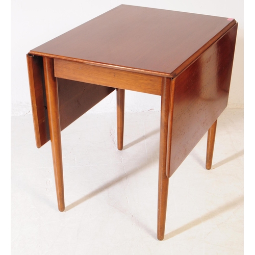 584 - British Modern Design - A mid 20th century teak wood drop leaf dining table and chairs. The dining t... 