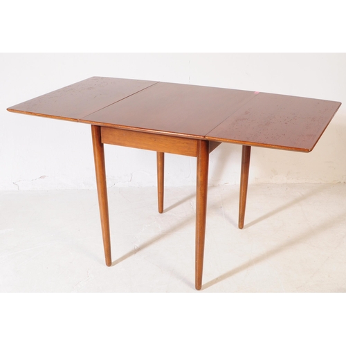 584 - British Modern Design - A mid 20th century teak wood drop leaf dining table and chairs. The dining t... 