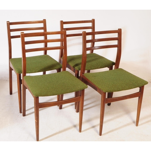 584 - British Modern Design - A mid 20th century teak wood drop leaf dining table and chairs. The dining t... 