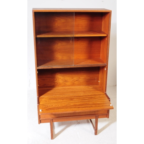 585 - British Modern Design - A mid 20th century teak bookcase / side cabinet. The cabinet raised on taper... 