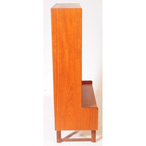 585 - British Modern Design - A mid 20th century teak bookcase / side cabinet. The cabinet raised on taper... 