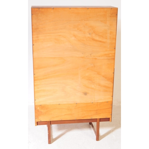 585 - British Modern Design - A mid 20th century teak bookcase / side cabinet. The cabinet raised on taper... 