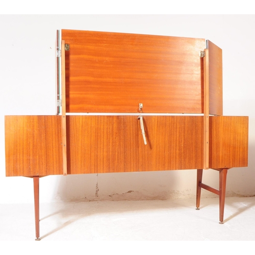 587 - British Modern Design - A mid 20th century teak veneer dressing table. The dresser raised on tapered... 