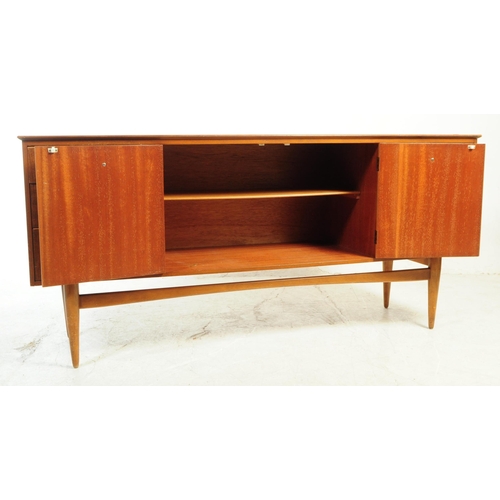 589 - British Modern Design - A mid 20th century teak veneer sideboard credenza. The sideboard raised on t... 