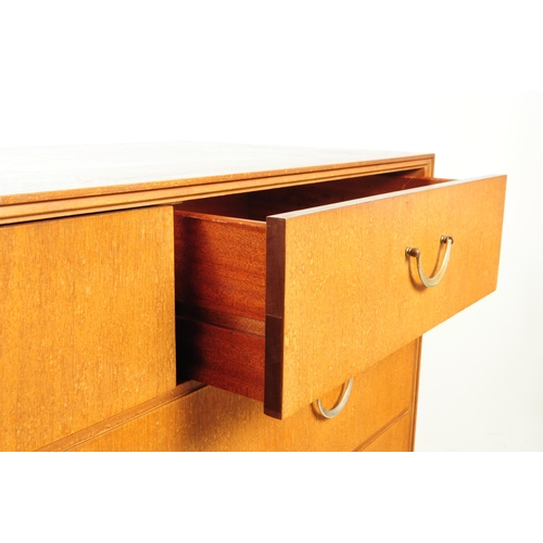 591 - British Modern Design - A mid 20th century teak veneer chest of drawers. The chest of drawers raised... 