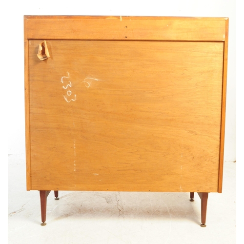 591 - British Modern Design - A mid 20th century teak veneer chest of drawers. The chest of drawers raised... 