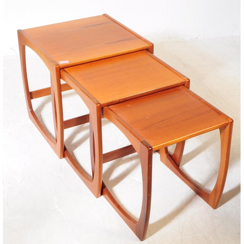 593 - British Modern Design - A mid 20th century teak wood nest of tables. The nest of side tables, raised... 