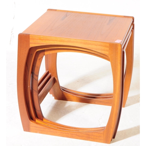 593 - British Modern Design - A mid 20th century teak wood nest of tables. The nest of side tables, raised... 