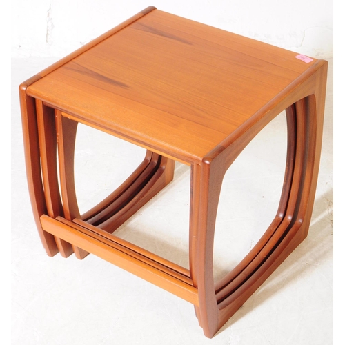 593 - British Modern Design - A mid 20th century teak wood nest of tables. The nest of side tables, raised... 