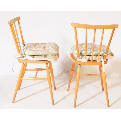 594 - Ercol - Model 391 - A pair of mid 20th century Ercol model 391 beech & elm wood dining chairs. The c... 