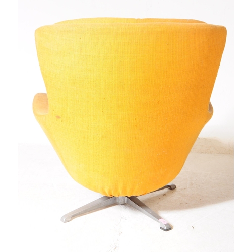 596 - British Modern Design - A mid 20th century circa 1960s swivel egg lounge armchair. The chair raised ... 