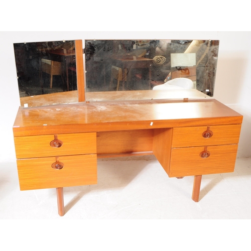 597 - British Modern Design - A mid 20th century teak veneer dressing table and stool. The dresser having ... 