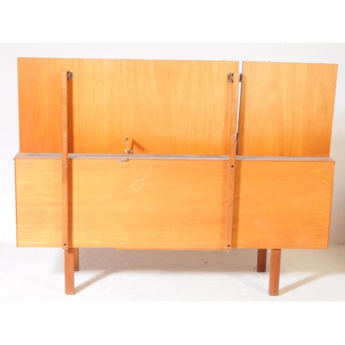 597 - British Modern Design - A mid 20th century teak veneer dressing table and stool. The dresser having ... 