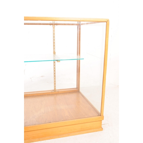 598 - A vintage 20th century haberdashery shop display cabinet. Rectangular form with glass top and sides,... 