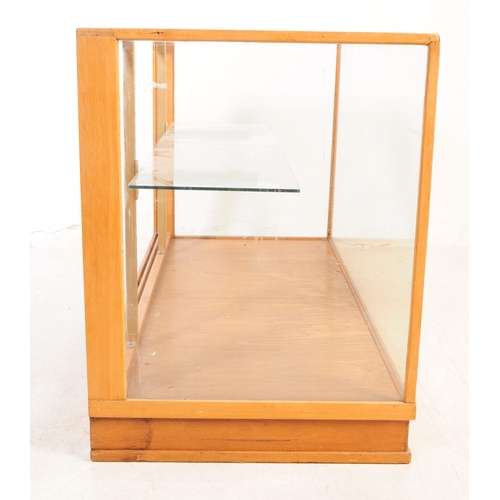 598 - A vintage 20th century haberdashery shop display cabinet. Rectangular form with glass top and sides,... 