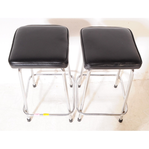 608 - A matching pair of retro 20th century leatherette bar stools. Each stool having padded black leather... 