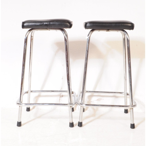 608 - A matching pair of retro 20th century leatherette bar stools. Each stool having padded black leather... 