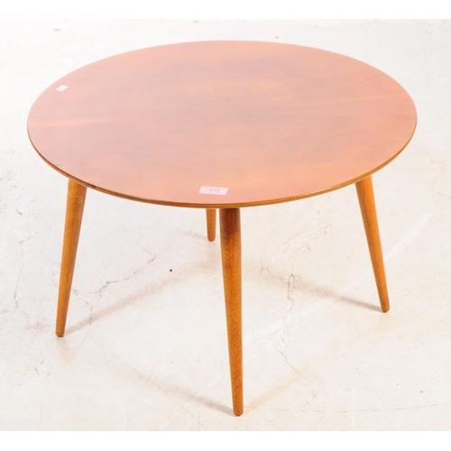 615 - British Modern Design - A mid Century small teak circular coffee table raised upon rounded tapered l... 