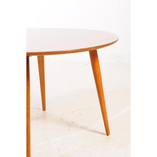 615 - British Modern Design - A mid Century small teak circular coffee table raised upon rounded tapered l... 