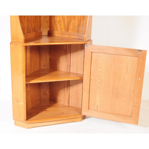 618 - Ercol - A retro 20th century Ercol beech and elm corner unit. The cabinet raised on a plinth base wi... 