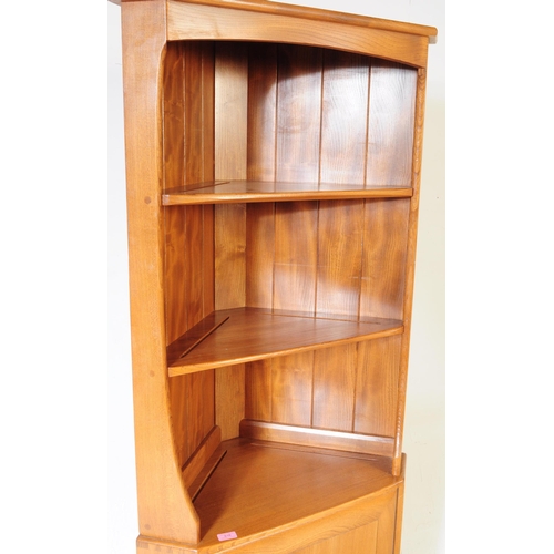 618 - Ercol - A retro 20th century Ercol beech and elm corner unit. The cabinet raised on a plinth base wi... 