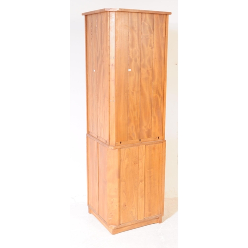 618 - Ercol - A retro 20th century Ercol beech and elm corner unit. The cabinet raised on a plinth base wi... 