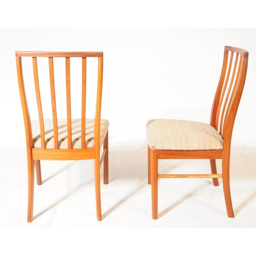 621 - Mcintosh - A set of four retro mid century teak dining chairs. Having slatted backrest on white upho... 