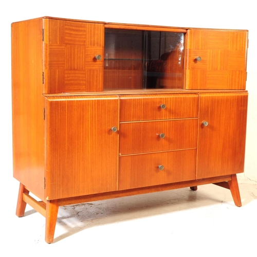 627 - Beautility Furniture - A mid century circa 1950s oak veneered sideboard credenza. Bow front top sect... 