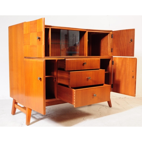 627 - Beautility Furniture - A mid century circa 1950s oak veneered sideboard credenza. Bow front top sect... 