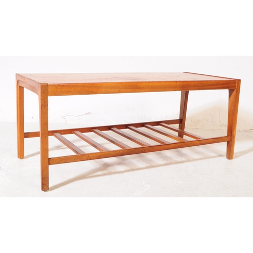 631 - British Modern Design - A mid century teak coffee / occasional table. Rectangular form with square u... 