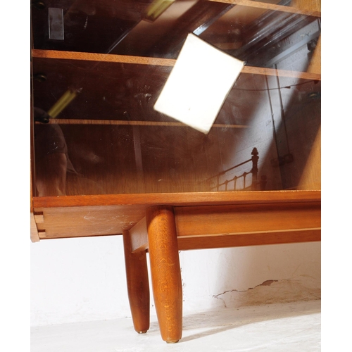 633 - British Modern Design - A vintage mid century teak bookcase cabinet. Rectangular form with twin slid... 