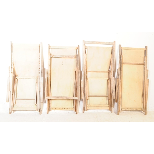 639 - A group of four vintage 20th century beech / garden folding deck chairs. Of teak construction with f... 