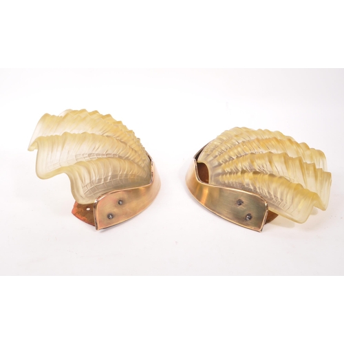 641 - A pair of early 20th century 1930s Art Deco clam shell wall lights shades. The lights having undulat... 