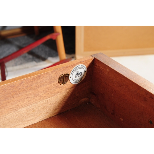 645 - Alfred Cox - A mid 20th century walnut chest of drawers. The chest of drawers raised on tapered legs... 