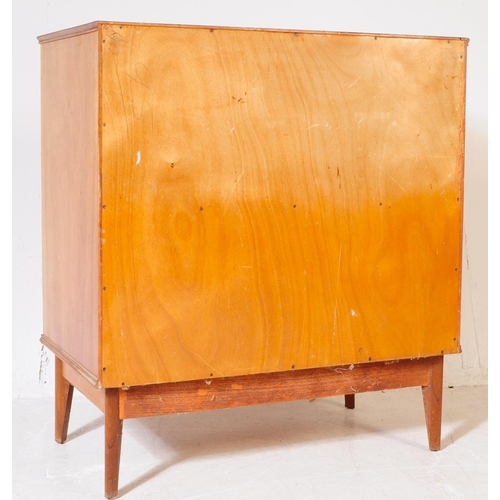 645 - Alfred Cox - A mid 20th century walnut chest of drawers. The chest of drawers raised on tapered legs... 