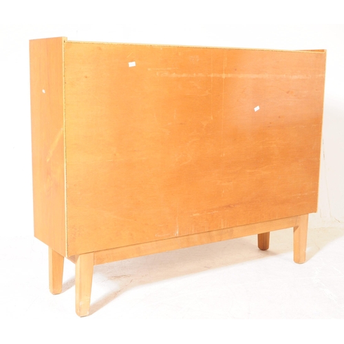 647 - British Modern Design - A mid 20th century teak glazed bookcase cabinet. The bookcase featuring a cu... 