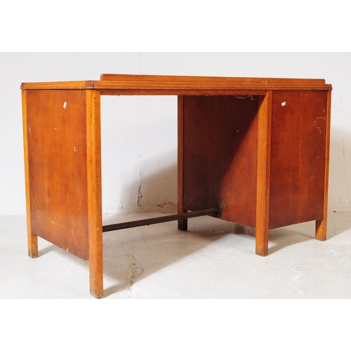 648 - A mid 20th century 1940s Air Ministry manner oak wood desk. The desk raised on block feet, having a ... 