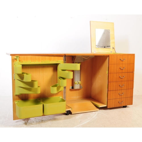 649 - British Modern Design - A large mid 20th century teak veneer sewing cabinet cupboard. Featuring a cu... 