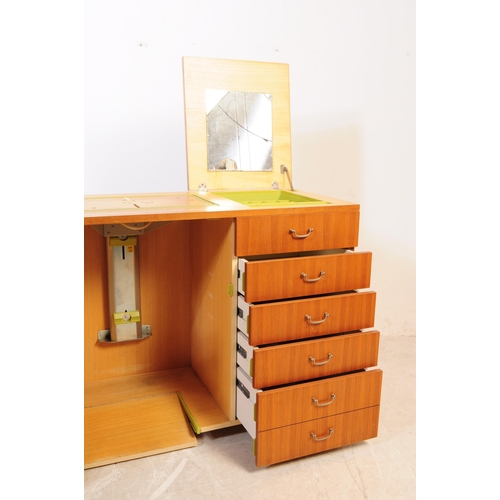 649 - British Modern Design - A large mid 20th century teak veneer sewing cabinet cupboard. Featuring a cu... 